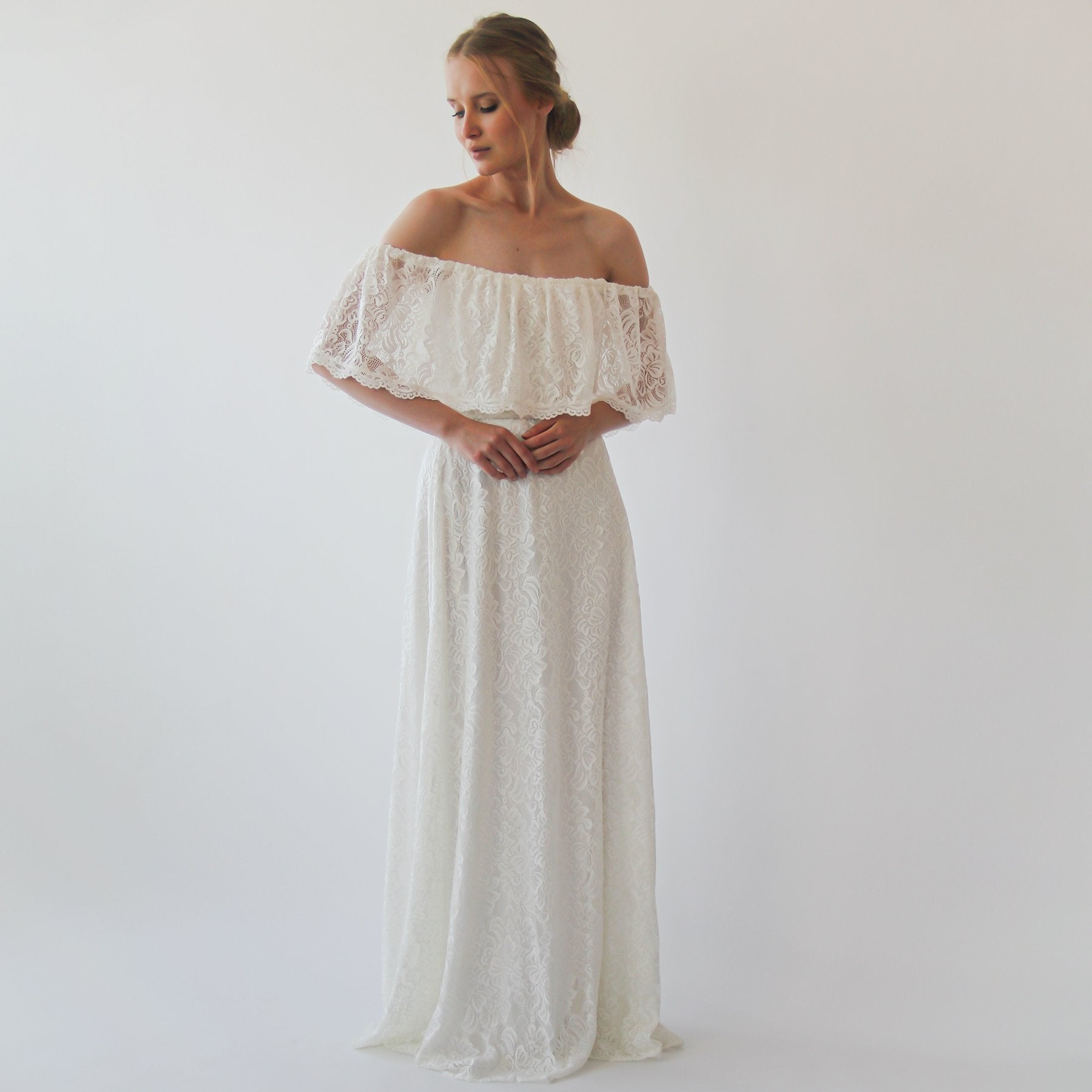 Bohemian off-shoulder ivory lace dress with crinkled ruffle, perfect for beach weddings and outdoor ceremonies.