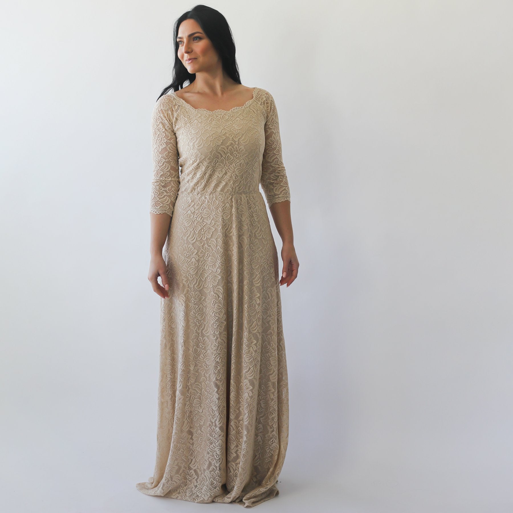 Woman wearing Solenara off-shoulder champagne wedding dress with floral lace texture and quarter-length sleeves.