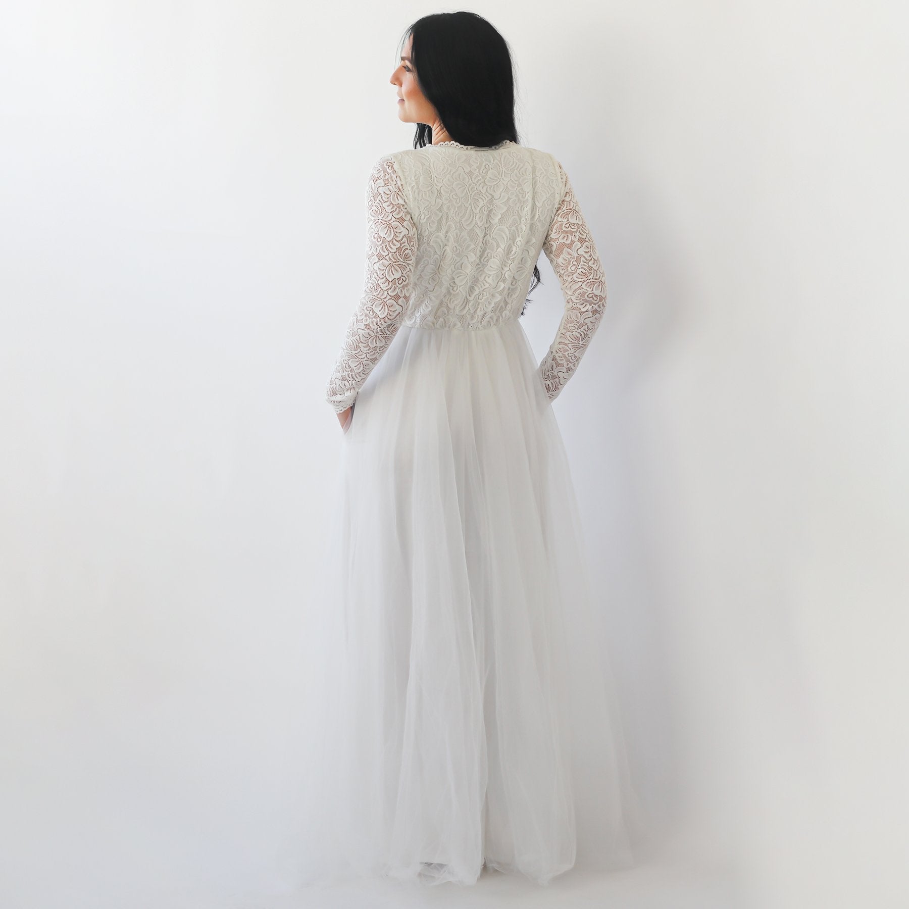 Rear view of Arvalie Tulle and Lace Wedding Gown with long sleeves, featuring a flowing tulle skirt and lace top, perfect for plus sizes.