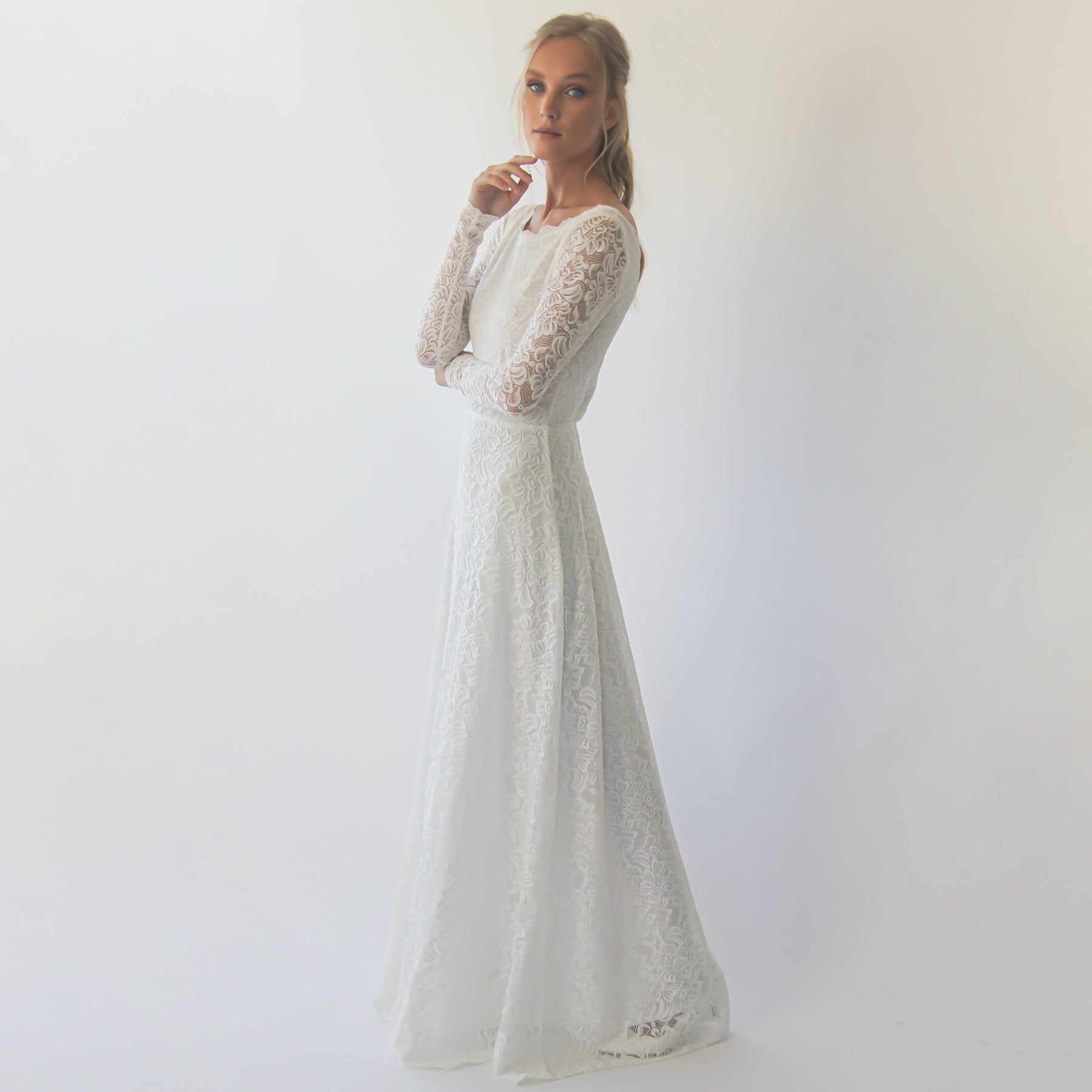 Belloria modest lace wedding dress with floral sash, featuring bell sleeves and boat neckline, full-length vintage gown elegance.