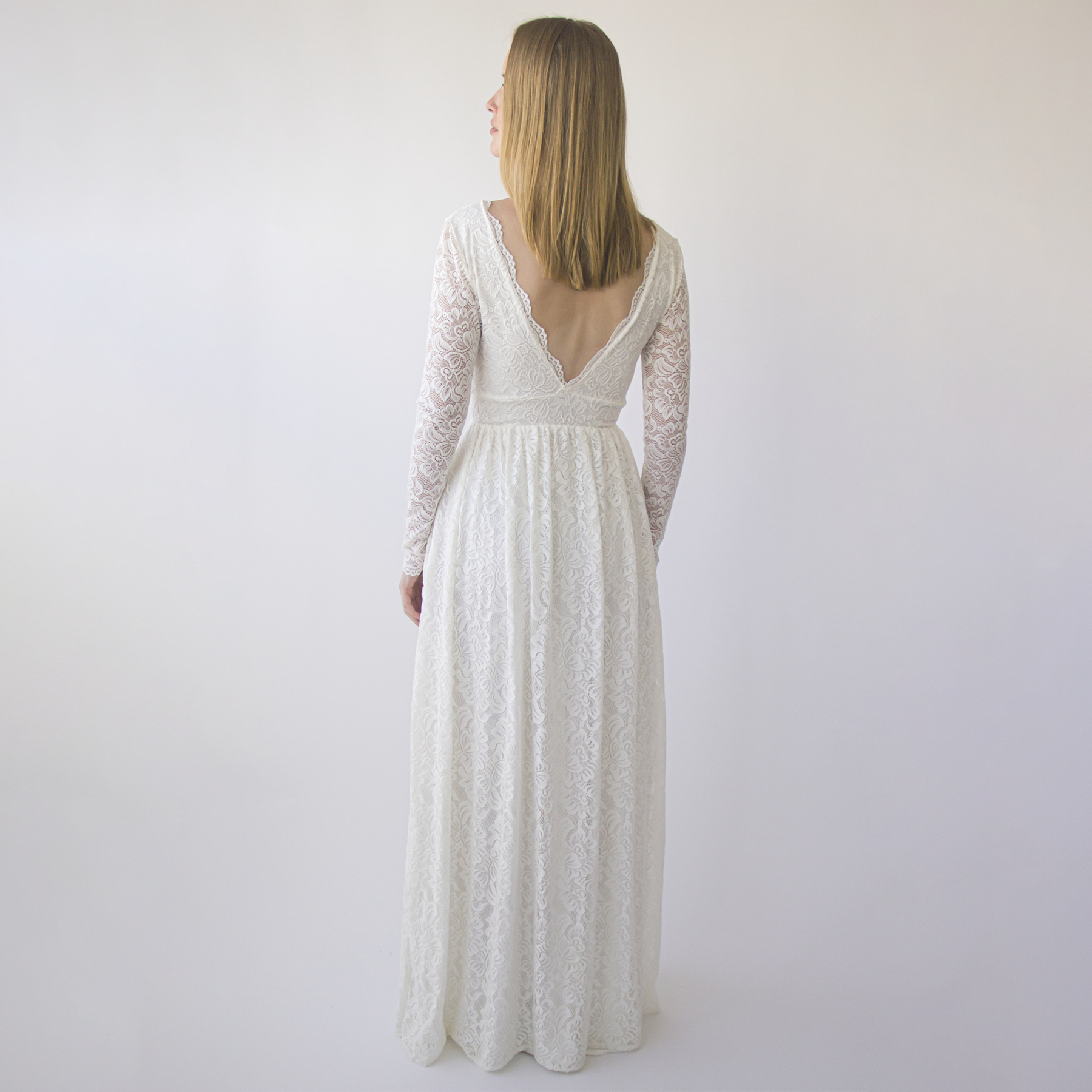 Thaleira Empire Waist Wedding Dress in ivory with lace, long sleeves, and V-back design, perfect for boho-themed garden weddings.