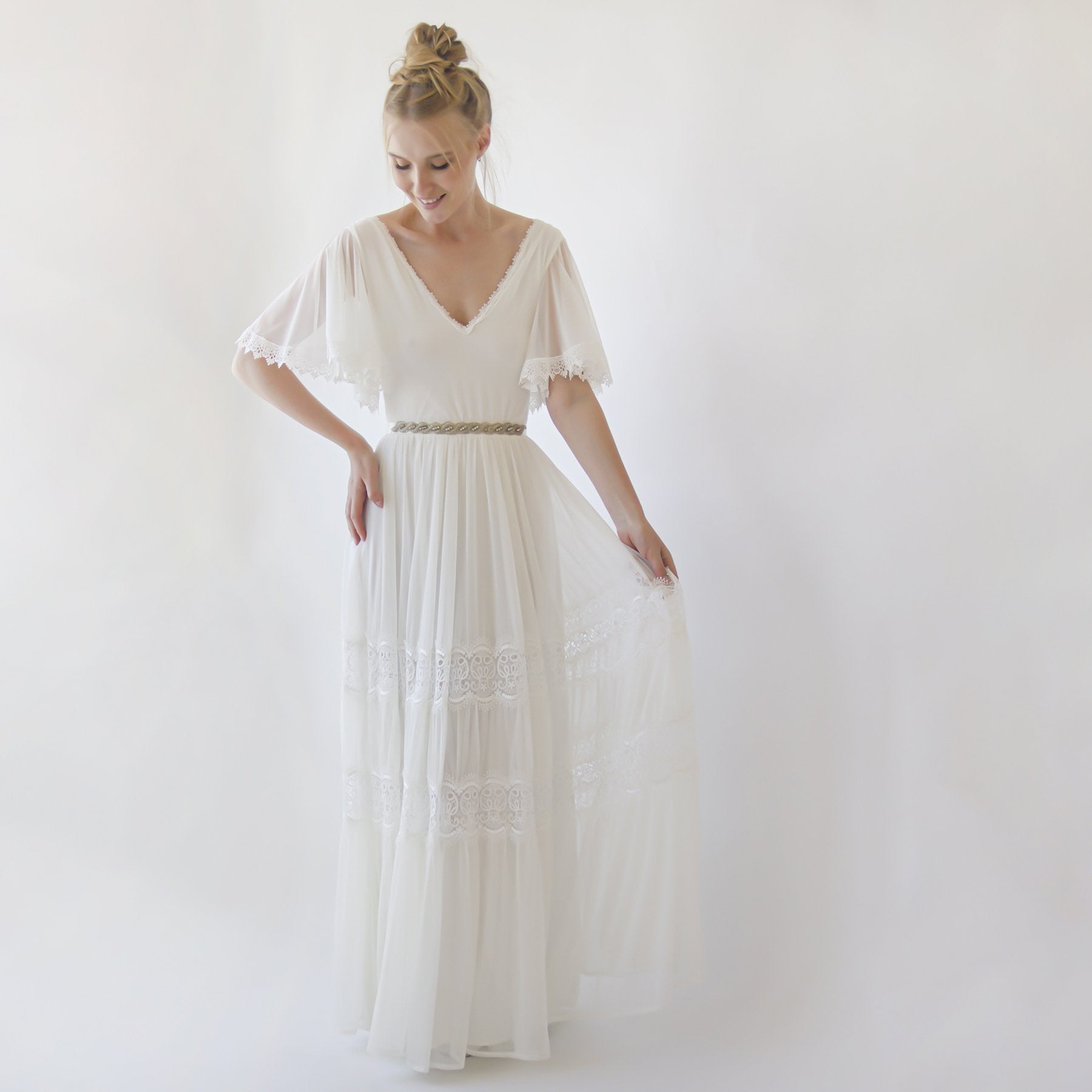 Alt Tag: Woman wearing Myrielle Chiffon Butterfly Wedding Dress with delicate butterfly sleeves and floral appliqué, creating a romantic silhouette.