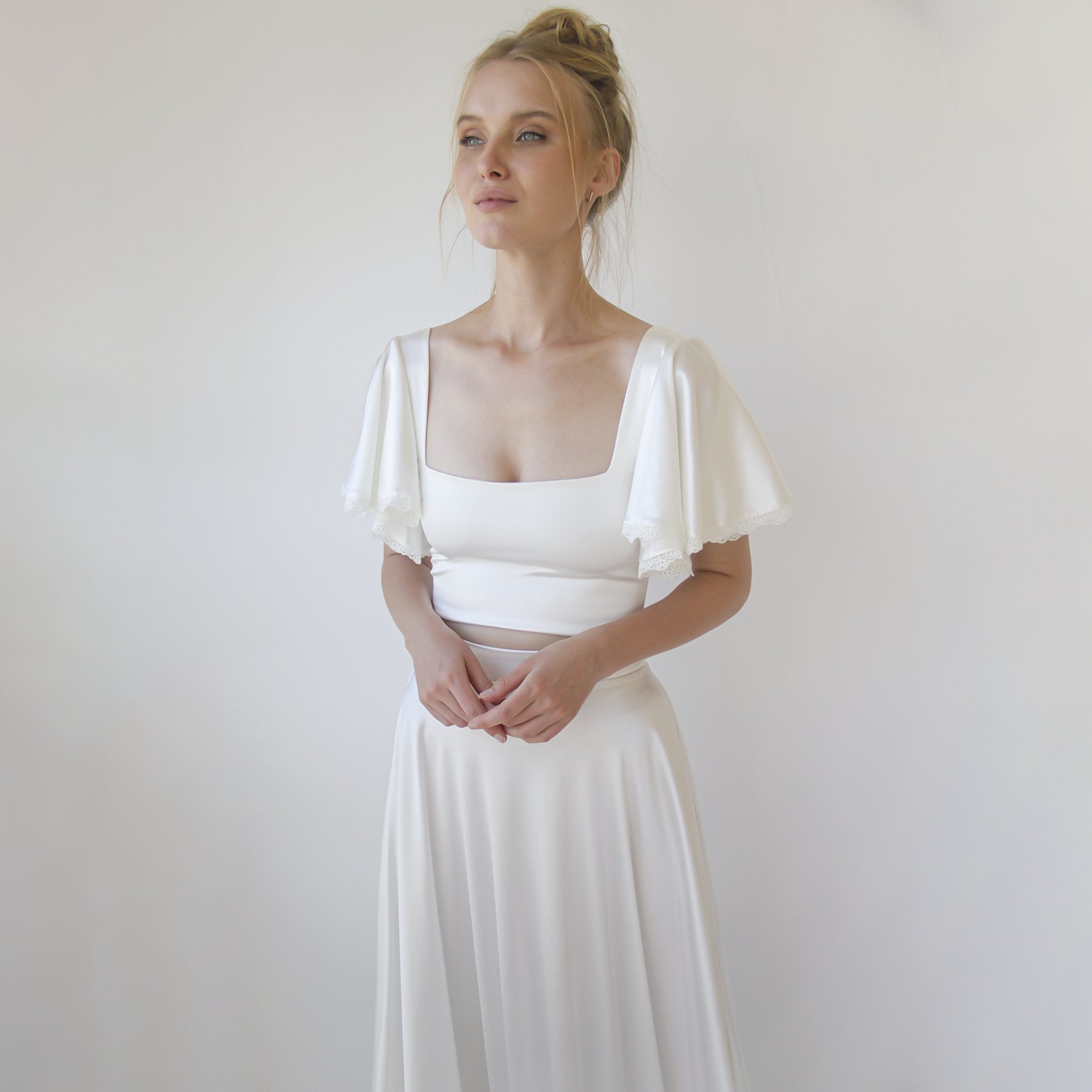 Woman wearing Noelia silky bridal crop top with butterfly sleeves and square neckline, showcasing modern bridal elegance.
