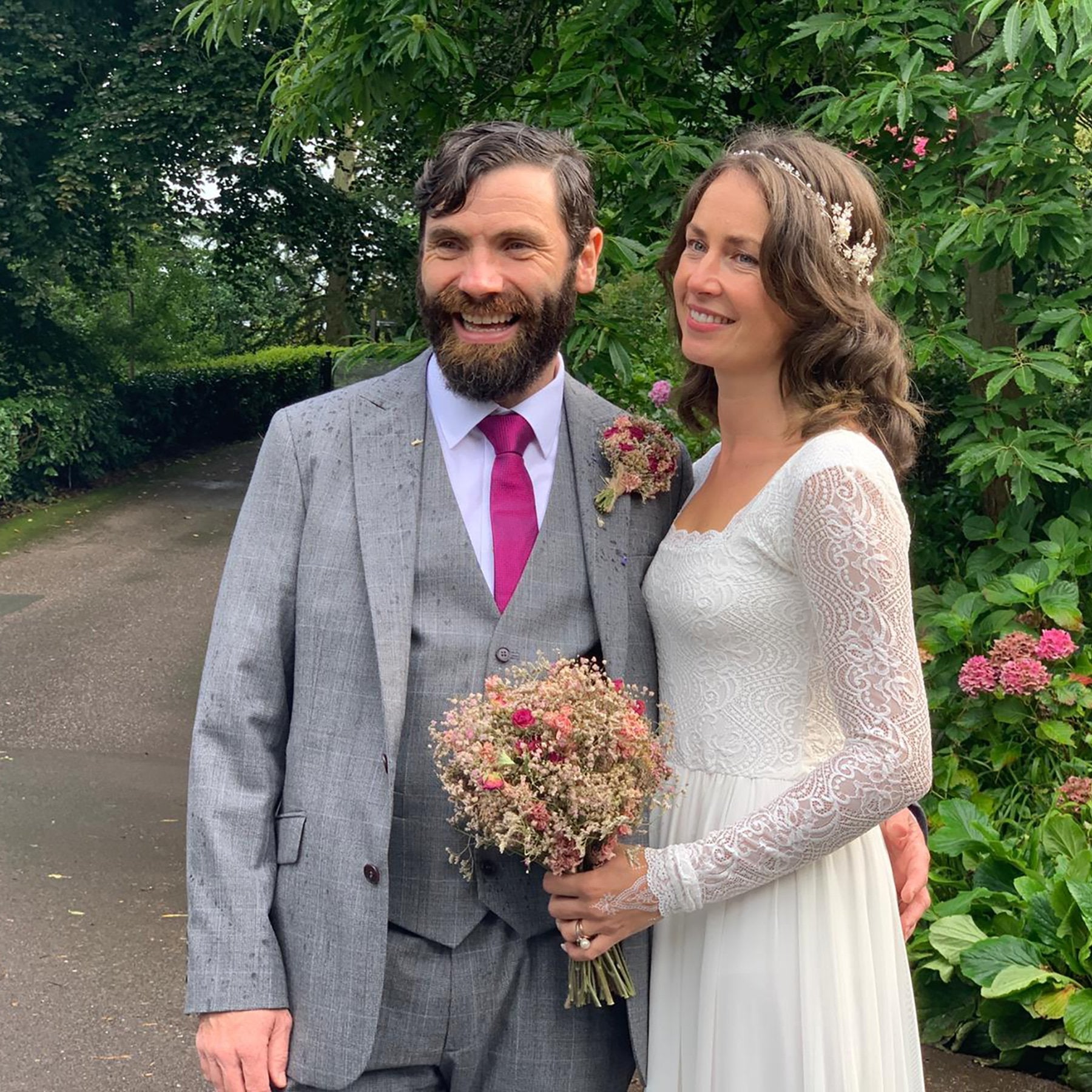 Bride in Naelira Square Neck Mesh Wedding Gown with groom in outdoor setting, showcasing lace bodice and chiffon skirt elegance.