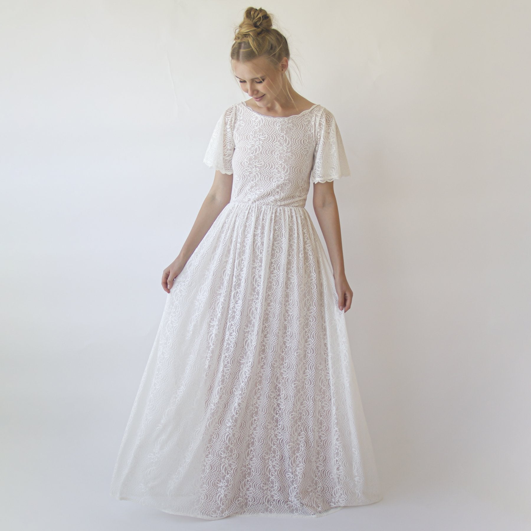 Woman wearing Maerelle Vintage Lace Wedding Gown with boat neckline, butterfly sleeves, ivory lace, ideal for elegant ceremonies.