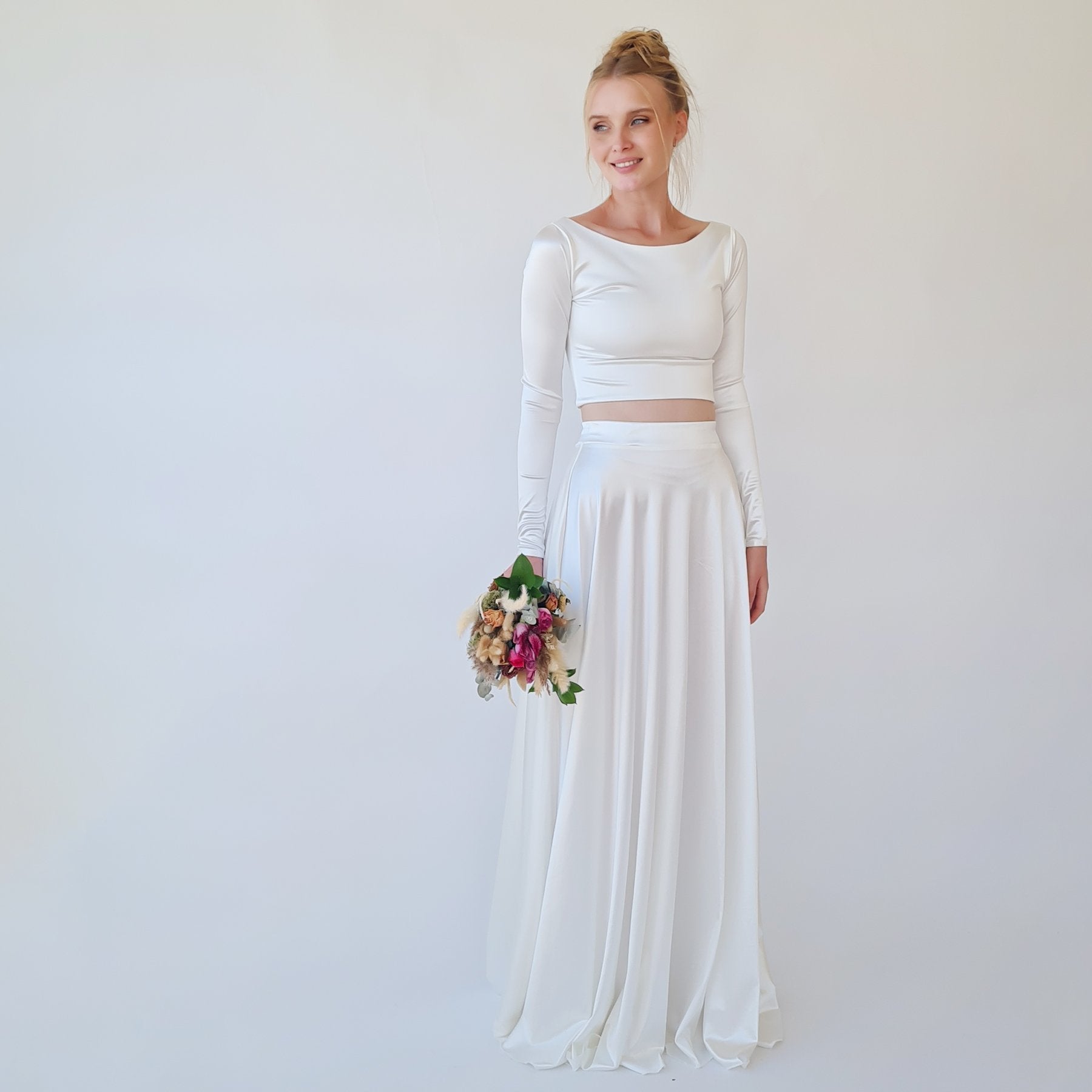 Silvanya Satin Two-Piece Wedding Dress with boat neckline crop top and flowing skirt, ideal for modern brides, model holding flowers