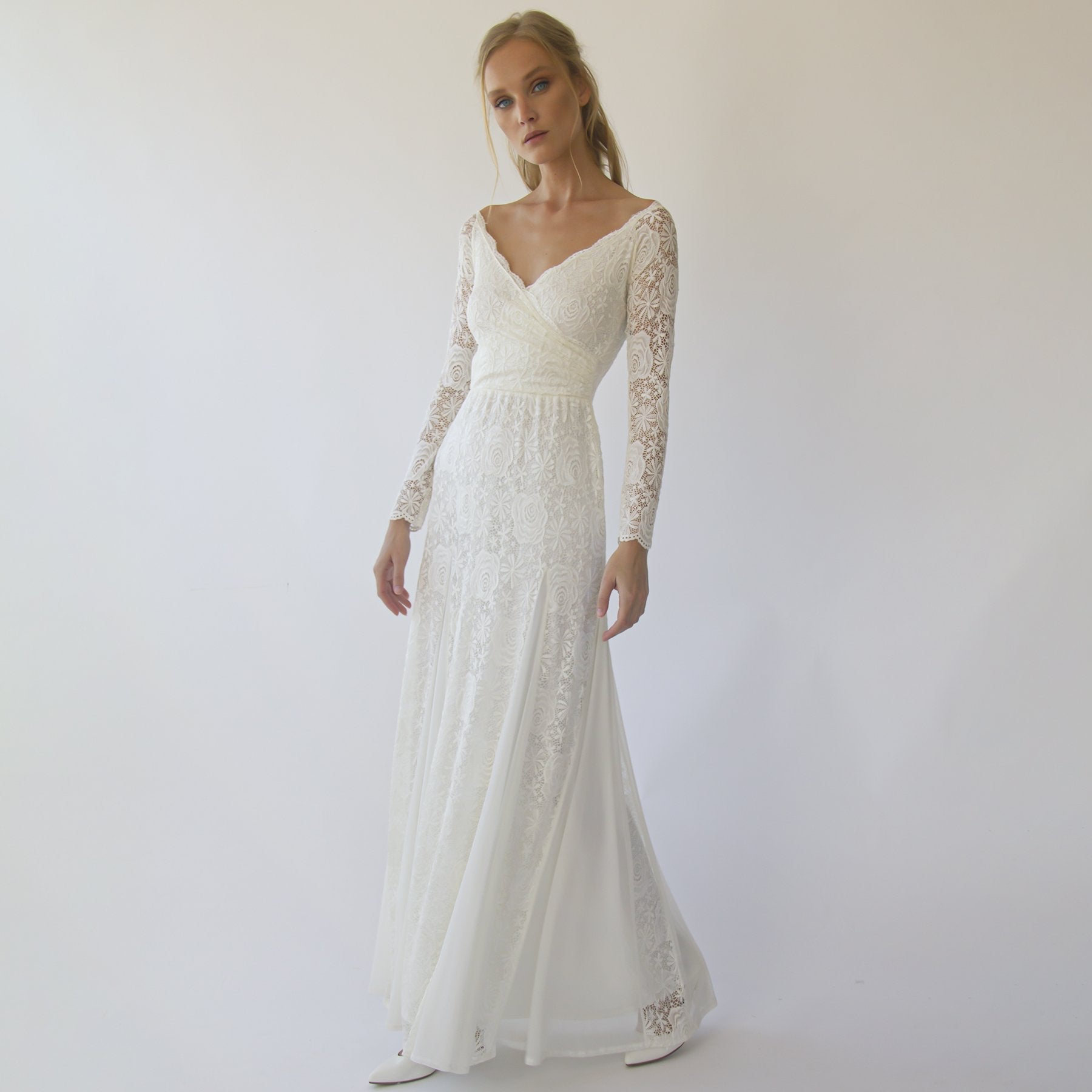 Ivory off-shoulder lace wedding gown with sleeves and mermaid silhouette for a classic romantic bridal look.