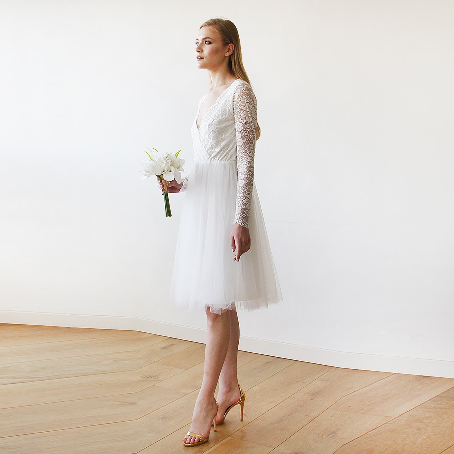 Ivory midi tulle wedding dress with lace sleeves, V-neckline, and wrap style, perfect for spring daytime weddings.