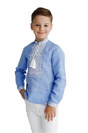 Boy wearing a blue Ukrainian Vyshyvanka shirt with white embroidery.