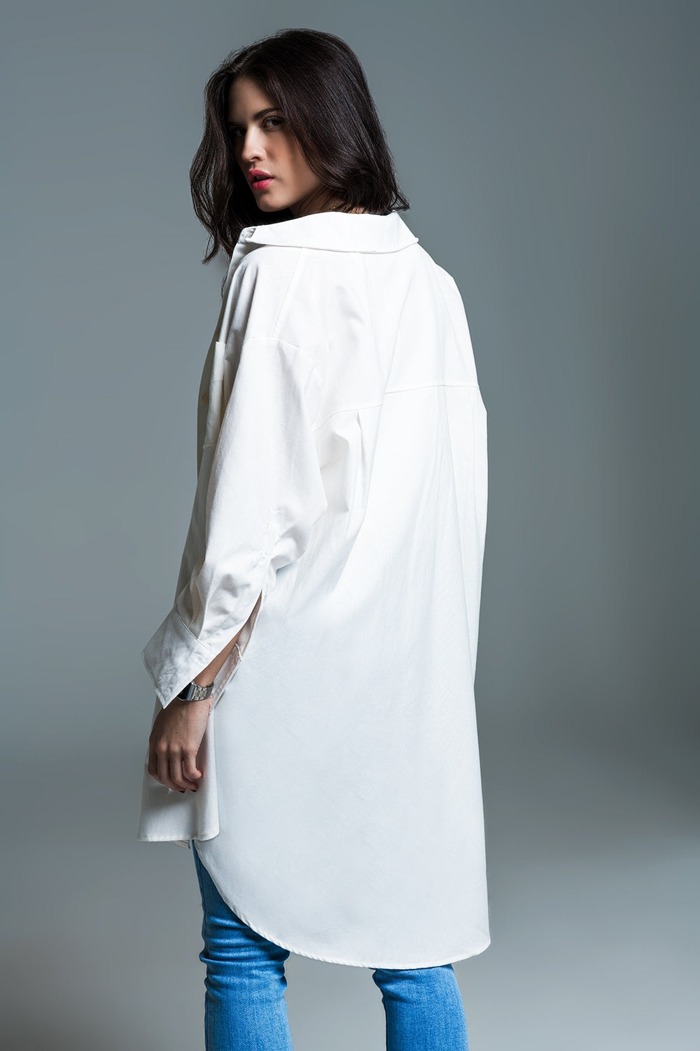 Woman wearing Naeryn Boyfriend Shirt with 3/4 sleeves, relaxed fit, and classic polo collar in crisp white, styled with jeans.