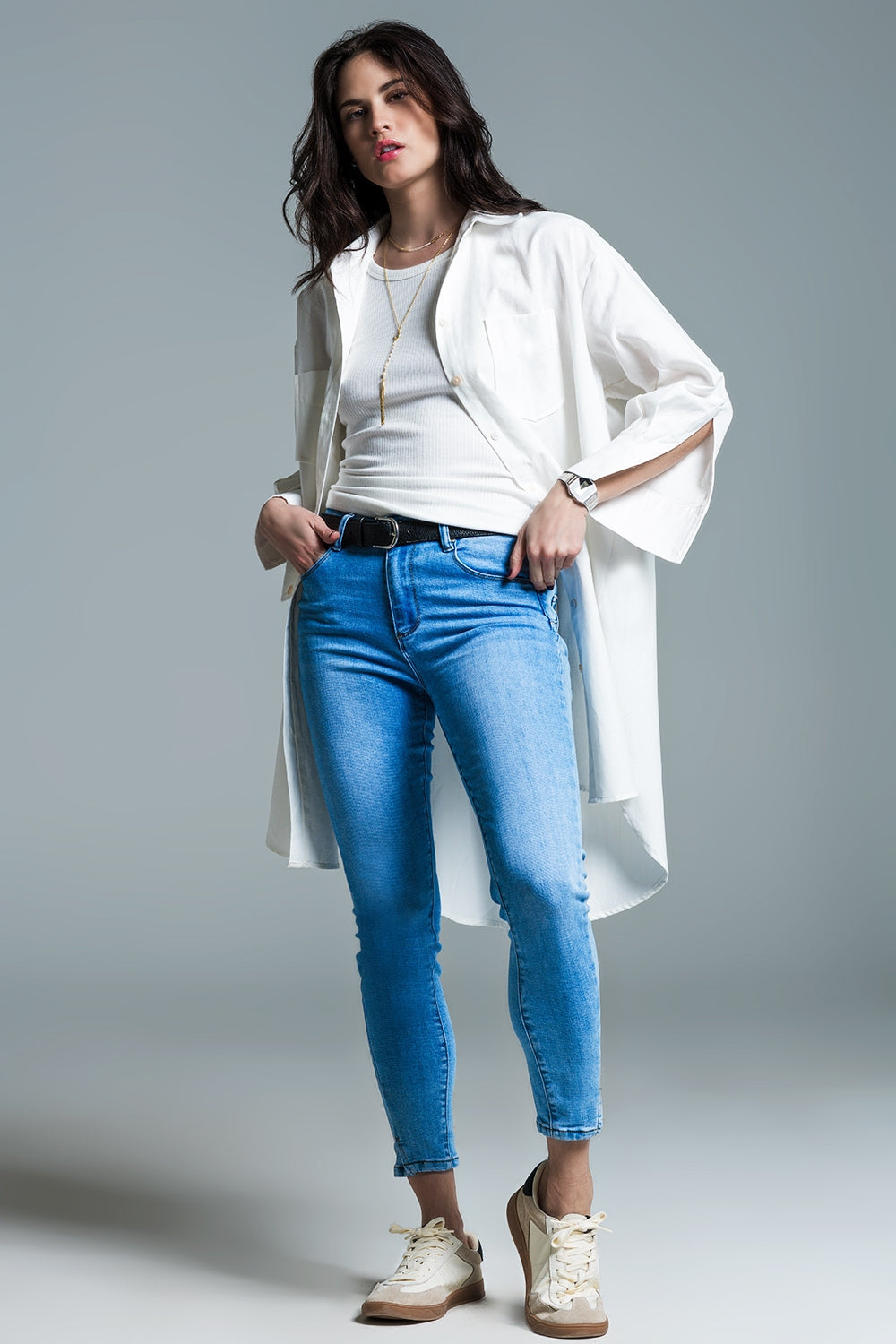 Woman wearing Naeryn Boyfriend Shirt with 3/4 sleeves, relaxed fit in crisp white, styled over jeans and sneakers for a casual look.