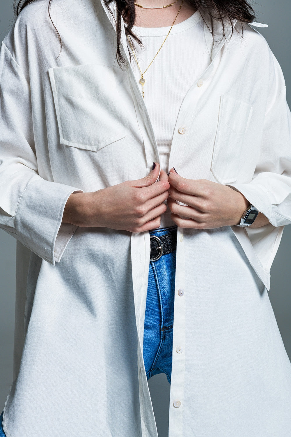 Woman wearing Naeryn Boyfriend Shirt with 3/4 sleeves and white inner top, showcasing relaxed menswear cut and classic polo collar.