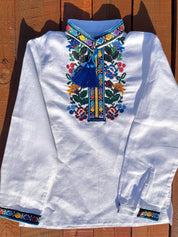 Boys' embroidered linen shirt with traditional Ukrainian vyshyvanka floral patterns, multicolor embroidery on chest, cultural attire.