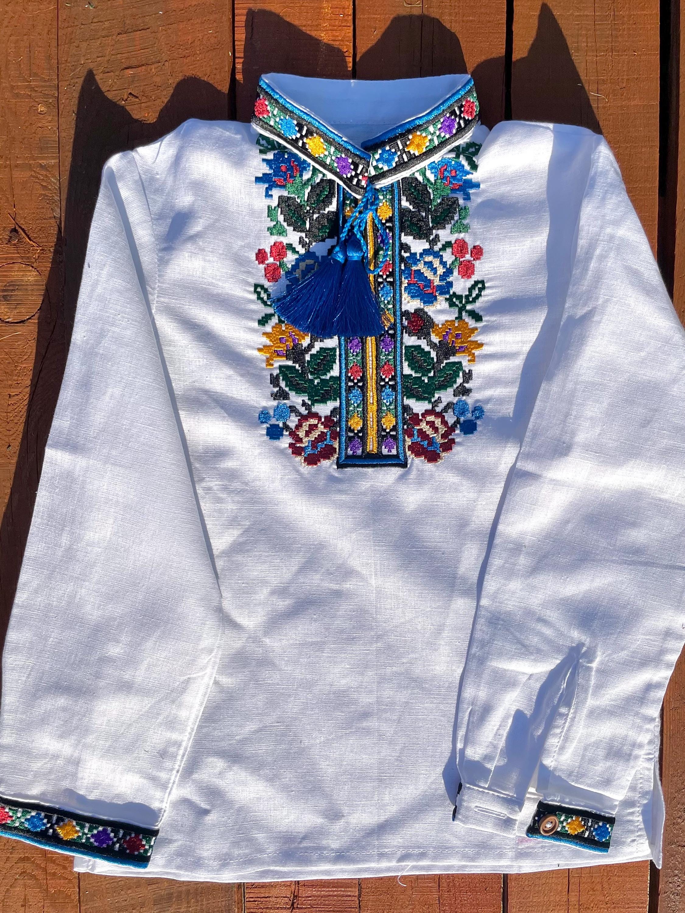 Boys' embroidered linen shirt with traditional Ukrainian vyshyvanka floral patterns, multicolor embroidery on chest, cultural attire.