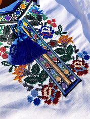 Close-up of embroidered multicolor floral design on a boys' linen shirt, inspired by traditional Ukrainian vyshyvanka patterns.
