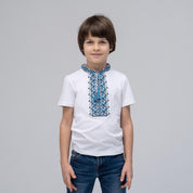 Boy wearing short sleeve Ukrainian vyshyvanka shirt with blue geometric embroidery, stand-up collar, ideal for summer.