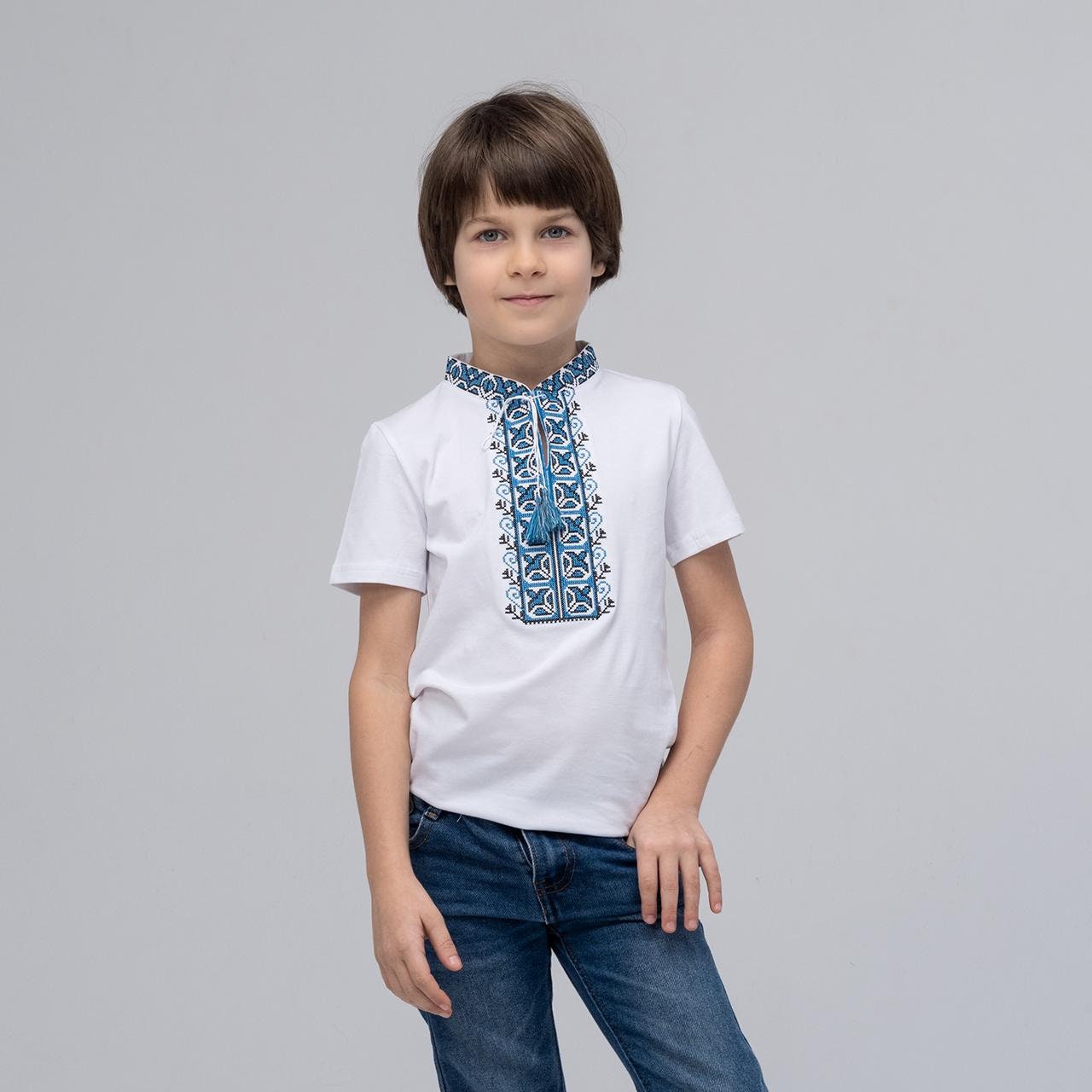Boy wearing a blue embroidered Ukrainian vyshyvanka shirt with short sleeves, perfect for summer and casual wear.