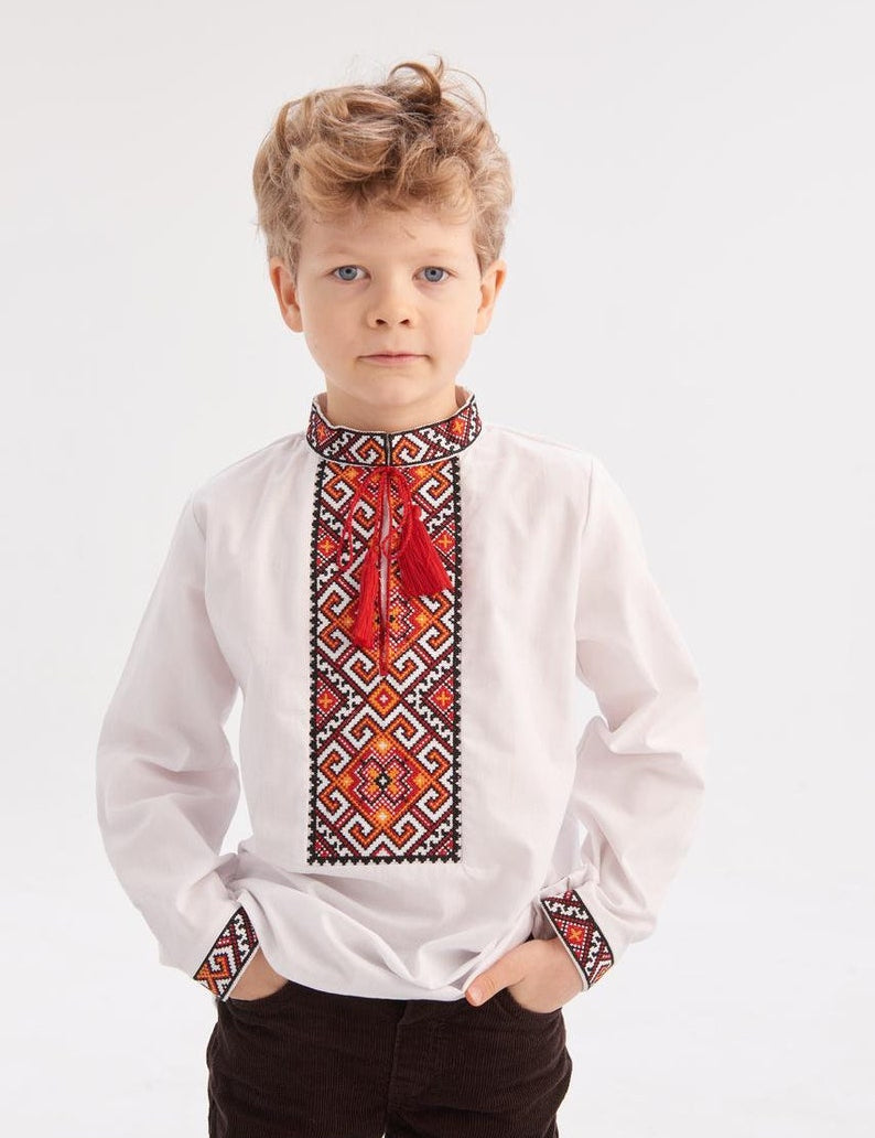 Boy wearing a Ukrainian embroidered shirt "Miron" with red and black geometric patterns, ideal for cultural events, ages 5-12.