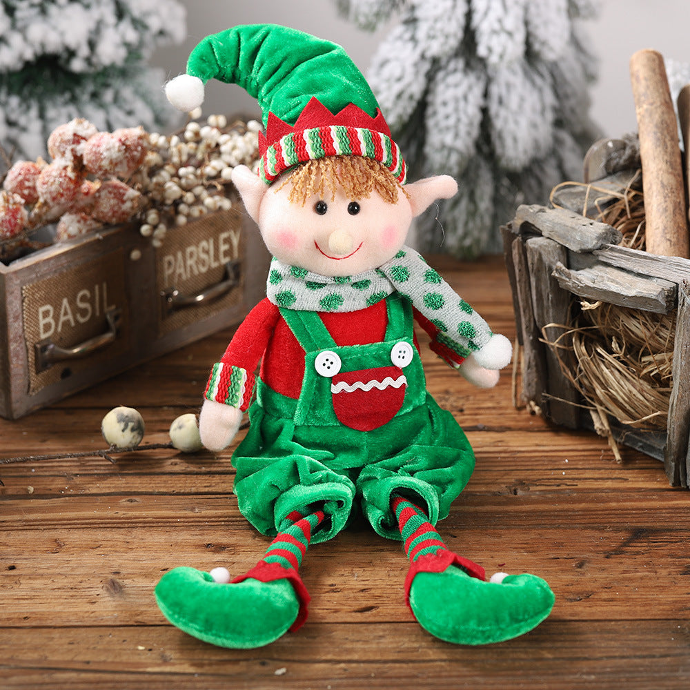 Christmas hanging legs sitting doll ornament in green outfit and hat, festive holiday home decoration for Christmas décor.