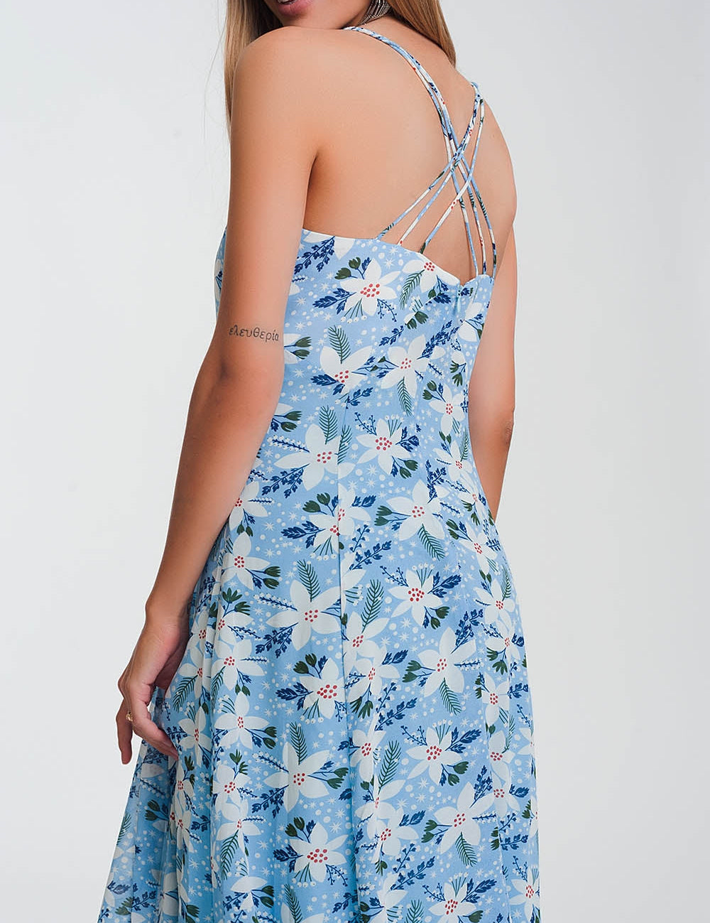 Back view of Ismeria Blue Floral Maxi Dress with cami straps, showcasing vibrant print and flowing silhouette for summer style.