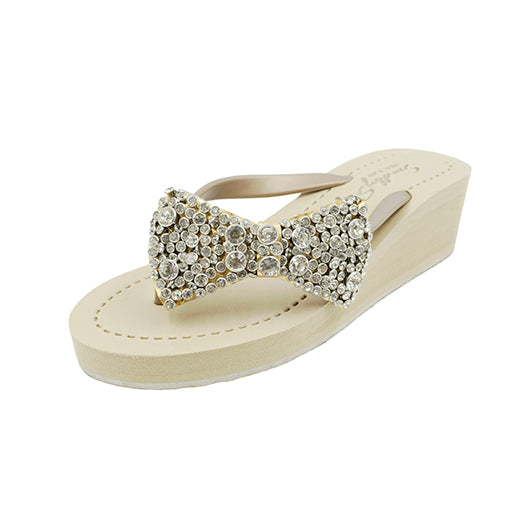 Celestina Bow Mid-Wedge Sandals with crystal bow, vegan leather, and mid-height wedge, perfect for summer elegance and comfort.