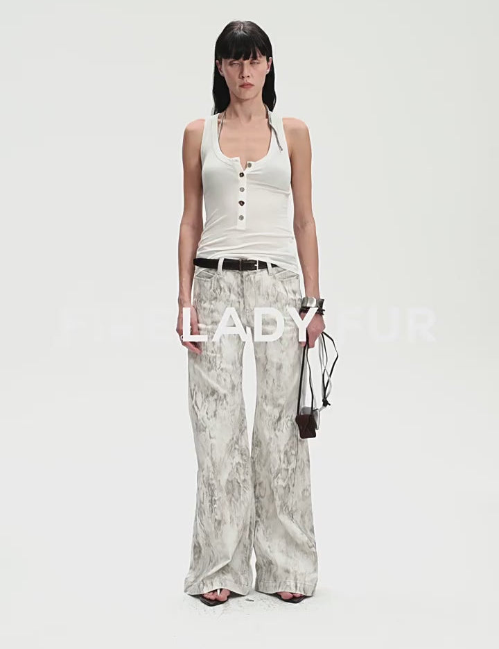 Woman wearing a Lureva U-Henley Vest with wide straps and soft armholes, paired with printed wide-legged pants.