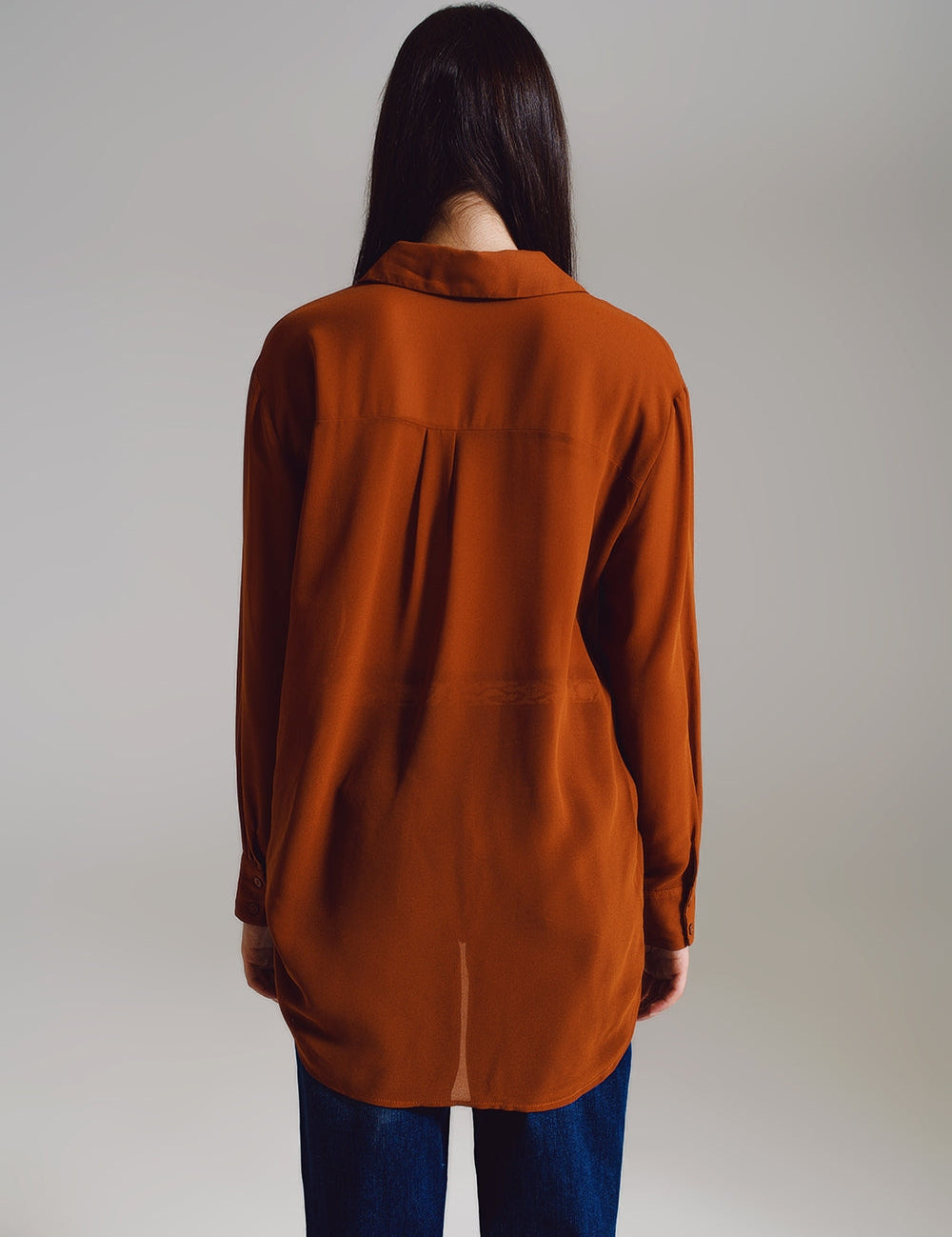 Woman wearing Cymirel Chiffon Polo Blouse in camel color, showcasing the relaxed fit and elegant design from the back view.
