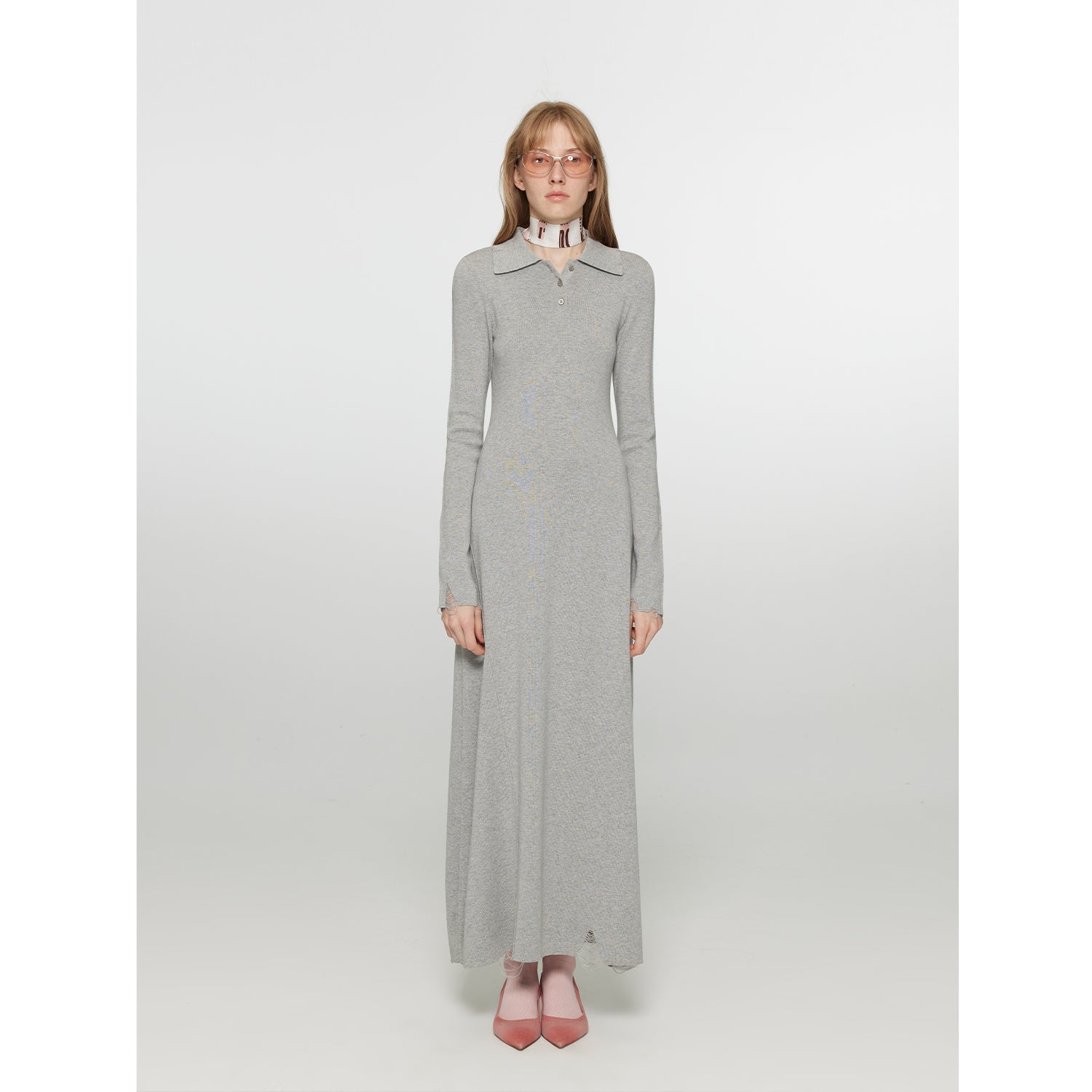 Model wearing Clarisse Polo Knit A-Line Dress with soft collar and cinched waist, highlighting elegant long knit silhouette.