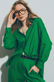 Woman wearing Theryn Relaxed Cotton Shirt in green, styled with trousers, showcasing laid-back, breathable design and comfort.