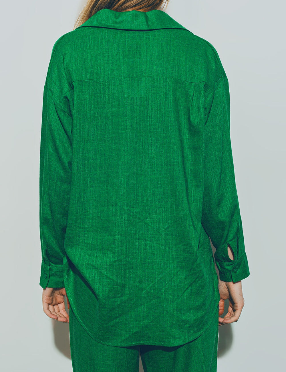 Back view of Theryn Relaxed Cotton Shirt in green, featuring a polo collar and long sleeves, showcasing a loose and breathable silhouette.