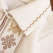 Cream Ukrainian embroidered baby onesie detail with traditional Vyshyvanka patterns, perfect for special occasions and gifts.