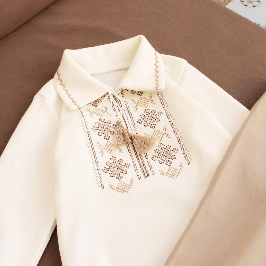 Cream baby boy onesie with Ukrainian embroidery, Vyshyvanka-style, long sleeve bodysuit for special occasions.