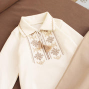 Cream baby boy onesie with Ukrainian embroidery, Vyshyvanka-style, long sleeve bodysuit for special occasions.