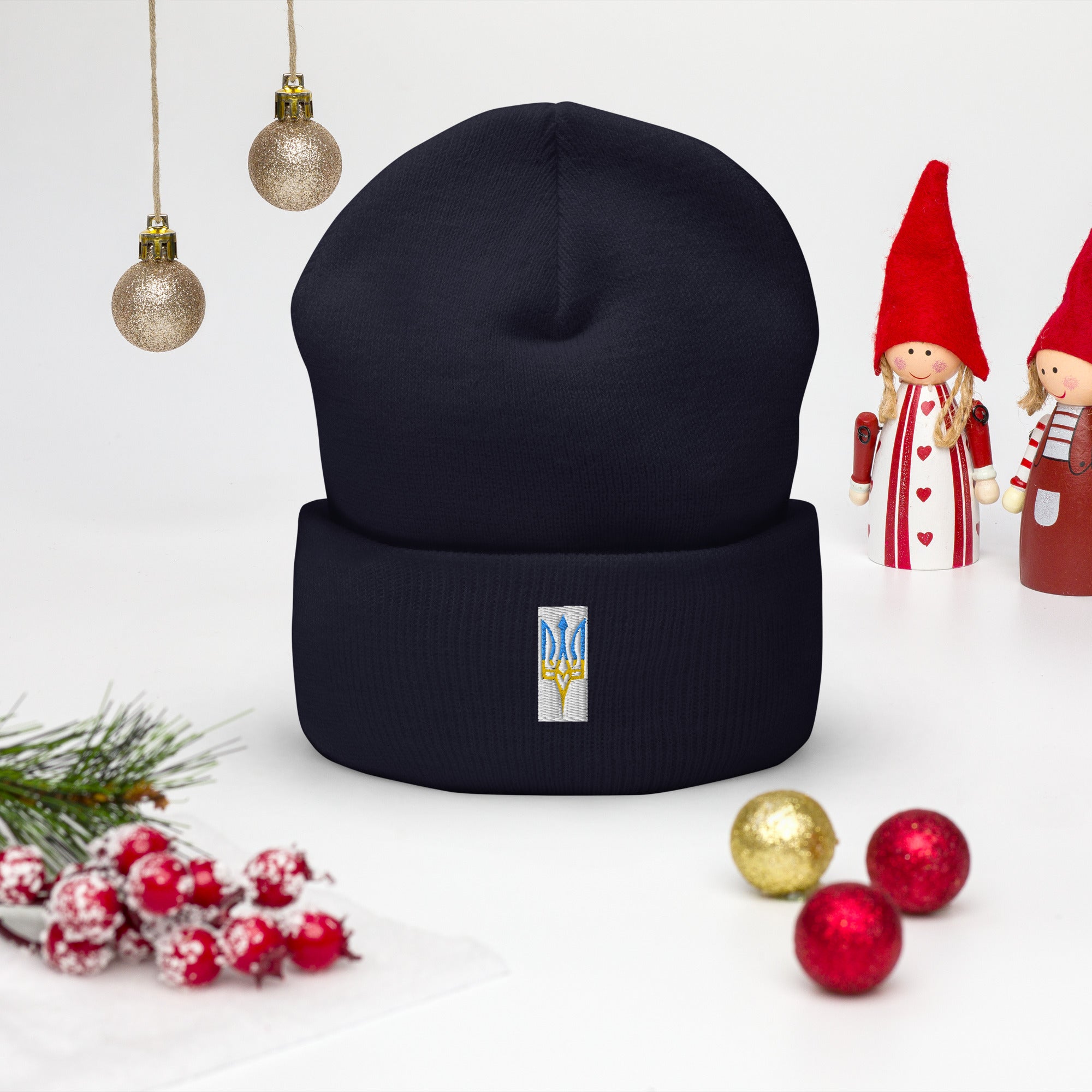 Unisex cuffed beanie with embroidered Ukrainian Tryzub design, surrounded by festive decorations.