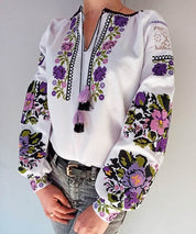 White Ukrainian Vyshyvanka blouse with purple floral embroidery on homespun fabric for women.