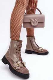 Woman wearing Florynne Floral-Laced Winter Boots with patterned tights and holding a matching taupe handbag.