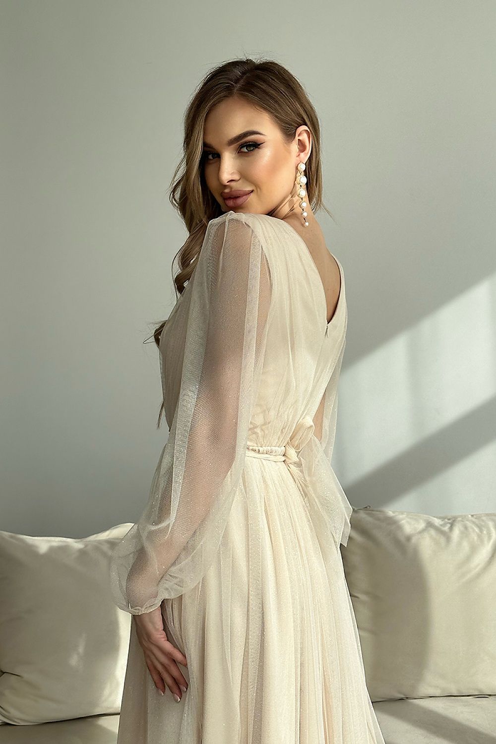Woman wearing Marleia Mesh-Layered Evening Midi Dress with sheer sleeves and a textured, flowing skirt.