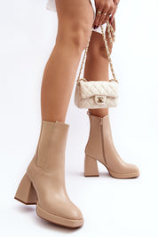 Vallorea Square-Toe Platform Boots in taupe with block heel, worn with a quilted handbag, showcasing autumn-winter chic style.