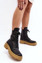 Black eco leather ankle boots with a thick tan platform and front lacing, perfect for seasonal transitions, offering style and comfort.