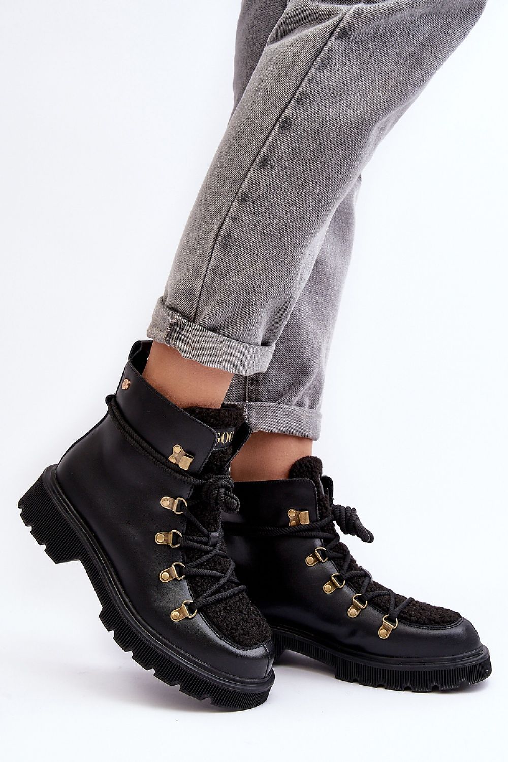 Larkwood Leather Winter Trapper Boots with durable leather exterior and lace-up design, worn with rolled-up jeans for a stylish look.
