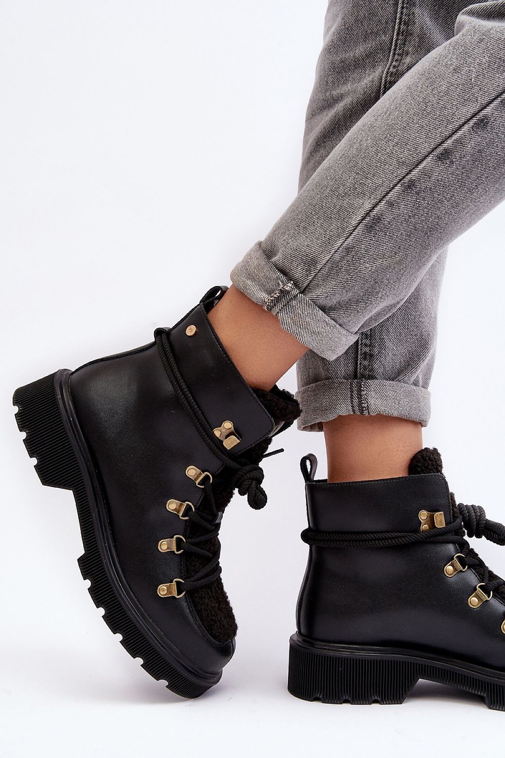 Larkwood Leather Winter Trapper Boots with lace-up design and reinforced heel, shown on model with folded jeans.