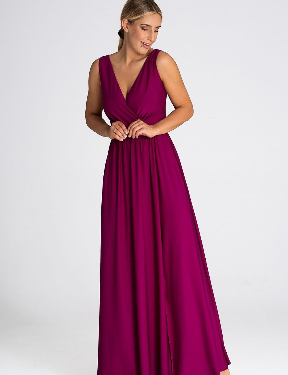 Woman wearing Eravine Deep V-Neck Maxi Dress with front slit, showcasing elegant silhouette for formal events and evening occasions.