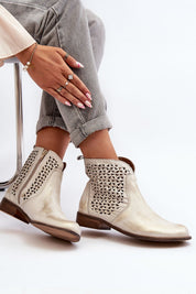 Velenna openwork leather zip boots with decorative detailing and low-profile heel, styled with jeans for trendy, comfortable wear.