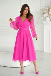 Woman wearing pink Marleia Mesh-Layered Evening Midi Dress with elegant sheer sleeves and flared skirt in stylish room setting.