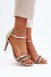 Woman wearing Elvarisse Zirconia Leather Stiletto Sandals with elegant zirconia detail and adjustable ankle strap for a refined look.