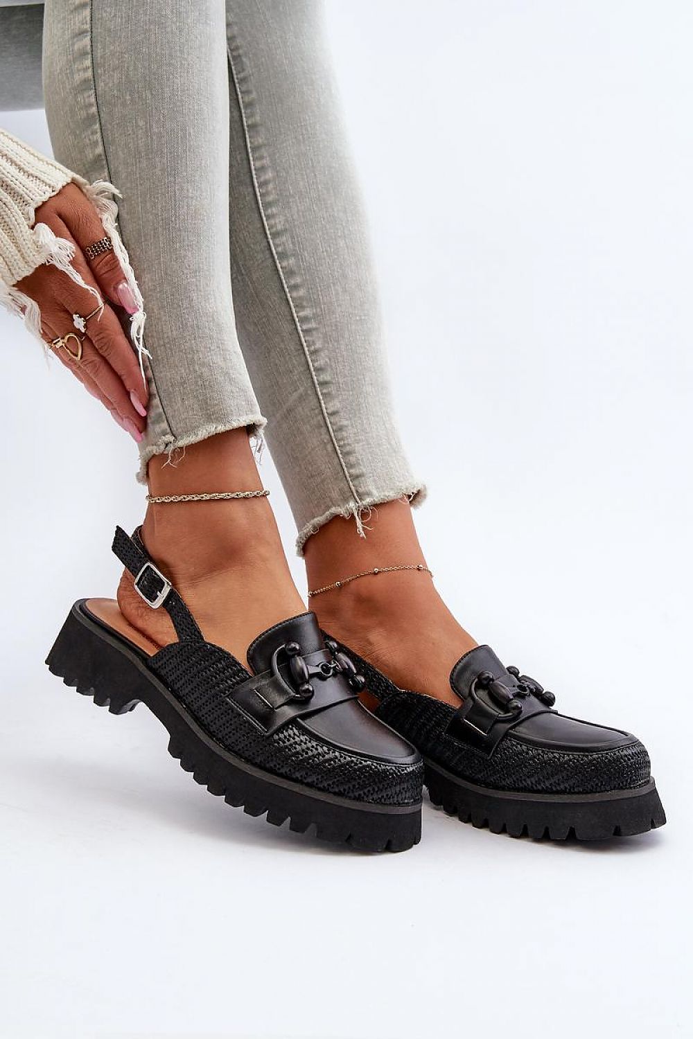 Larivena Buckled Low Platform Sandals in black eco leather with adjustable back strap, offering comfort and style for summer looks.