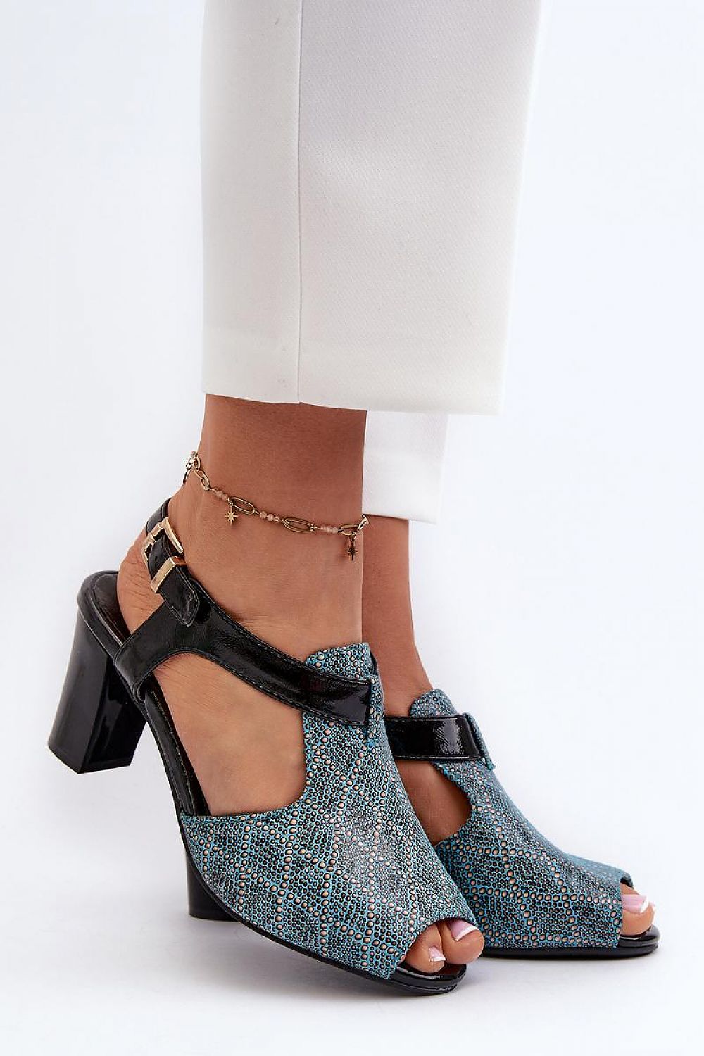 Carelia Buckled Post Heel Sandals in eco leather with adjustable strap and soft insole, offering stable elegance for warm-weather wear.