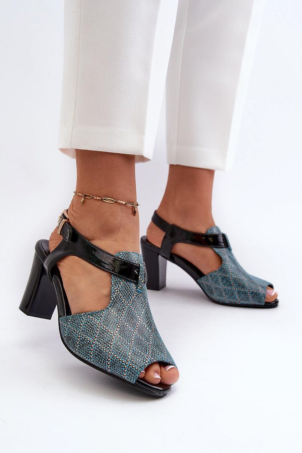 Woman wearing Carelia Buckled Post Heel Sandals in eco leather with adjustable strap, showcasing comfort and minimal elegance.