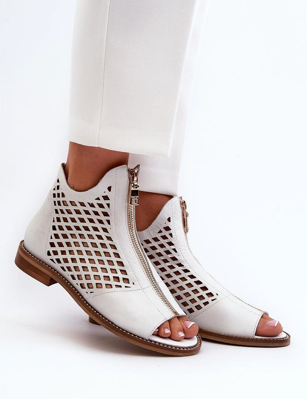 Almeryn Zipped Openwork Flat Sandals in white leather with front zipper, intricate openwork design, and embedded zircons for summer elegance.