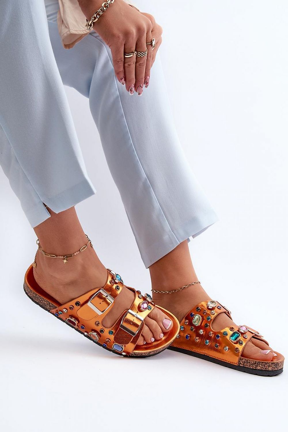 Woman wearing Merelina Crystal Buckle Platform Slides with eco leather and crystal embellishments, featuring a cork-inspired platform.